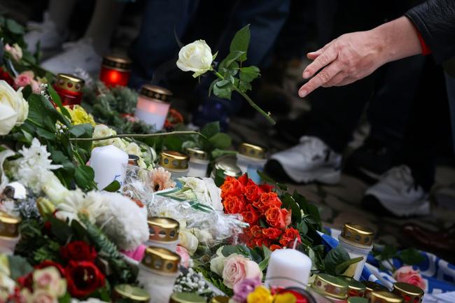 Well wishers lay flowers near the site of a car-ramming attack on a Christmas market in Magdeburg