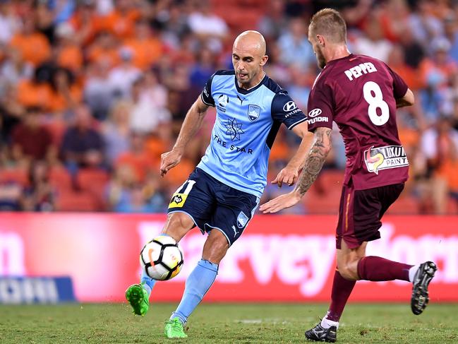 BRISBANE, AUSTRALIA - JANUARY 08:  Adrian Mierzejewski of Sydney takes on the defence during the round 15 A-League match between the Brisbane Roar and Sydney FC at Suncorp Stadium on January 8, 2018 in Brisbane, Australia.  (Photo by Bradley Kanaris/Getty Images)