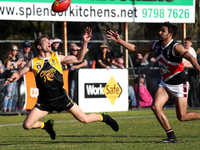 YCW defender Christian Ongarello has eyes for the ball as Bonbeach’s Trent Dennis-Lane closes in. Picture: Mark Dadswell