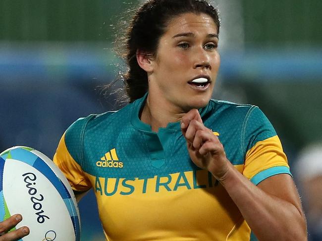 RIO DE JANEIRO, BRAZIL - AUGUST 06: Charlotte Caslick of Australia runs with the ball to score a try under pressure of Luisa Tisolo of Fiji during a Women's Pool A rugby match between Australia and Fiji on Day 1 of the Rio 2016 Olympic Games at Deodoro Stadium on August 6, 2016 in Rio de Janeiro, Brazil. (Photo by David Rogers/Getty Images)