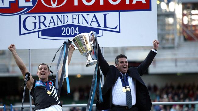 Port Adelaide captain Warren Tredrea and coach Mark Williams hold the AFL Premiership trophy aloft