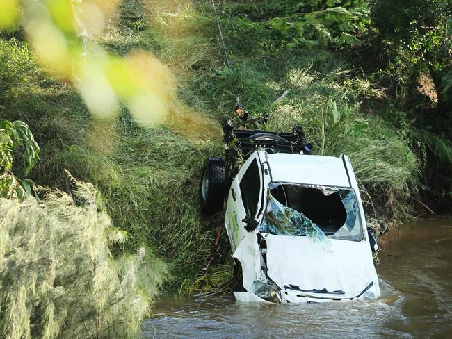 CANUNGRA, QUEENSLAND, AUSTRALIA - NewsWire Photos March 24, 2021:  Canungra Creek, Canungra Queensland, Queensland Police Divers and Queensland Fire Swift Water Rescue Team members remove a 4WD vehicle which was found submerged and upside down in Canungra Creek.NCA NewsWire / Scott Powick