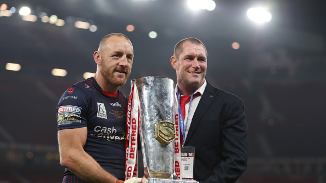 MANCHESTER, ENGLAND - OCTOBER 09: James Roby of St Helens holds the Grand Final Trophy with Kristian Woolf, Head Coach after victory in the Betfred Super League Grand Final match between Catalans Dragons and St Helens at Old Trafford on October 09, 2021 in Manchester, England. (Photo by Lewis Storey/Getty Images)