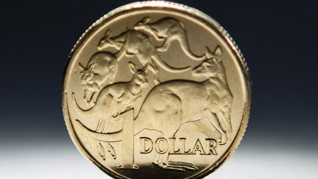 An Australian one-dollar coin is arranged for a photograph in Sydney, Australia, on Wednesday, April 17, 2013. Direct trading between the Australian dollar and yuan started on April 10. Photographer: Ian Waldie/Bloomberg