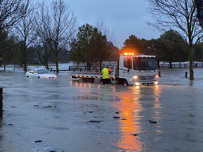 ***please credit Jenni Rohde*** , , A car is towed out of rising floodwaters near Traralgon. , , Gippsland woman Jenni Rohde was forced to pack up the essentials and evacuate from her Traralgon home.