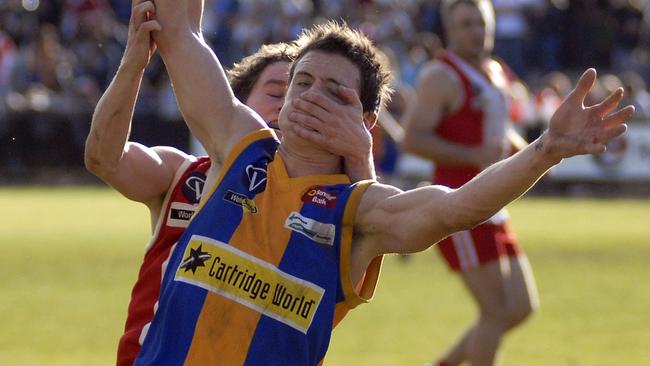 Golden Square’s Jack Geary gets a hand to the face from South Bendigo's Alex Galea during his first grand final in 2009. Picture: Yuri Kouzmin