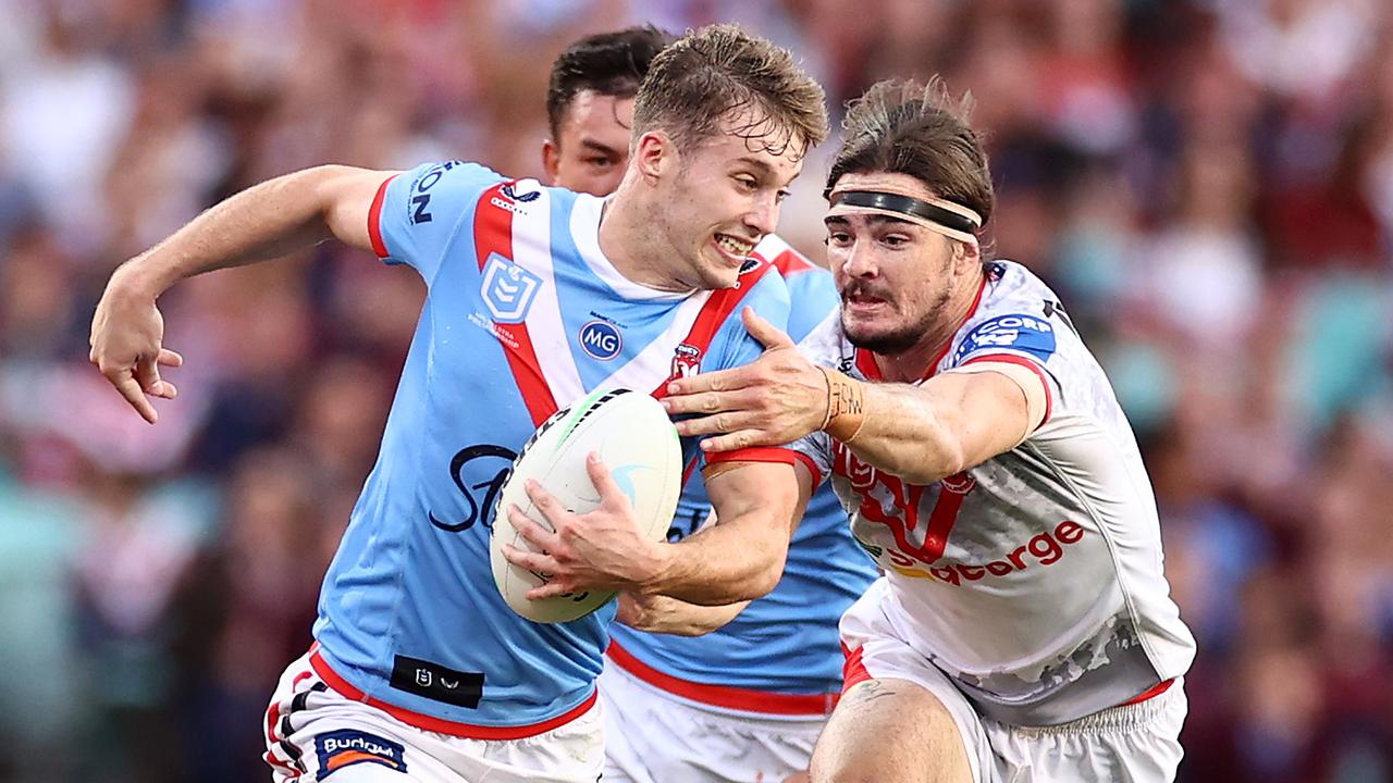 Sam Walker of the Roosters is tackled.