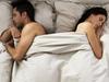 Couple Sleeping on Opposite Sides of Bed