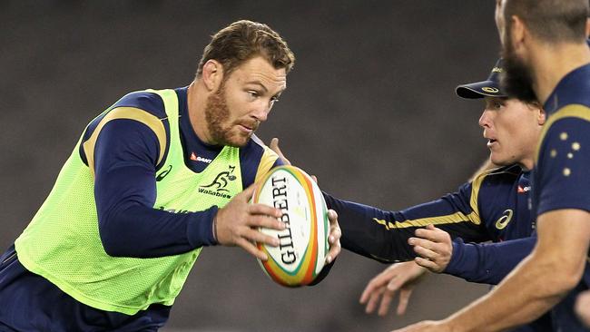 MELBOURNE, AUSTRALIA - JUNE 13: Scott Higginbotham runs the ball during an Australian Wallabies captain's run at Etihad Stadium on June 13, 2014 in Melbourne, Australia. (Photo by Robert Prezioso/Getty Images)