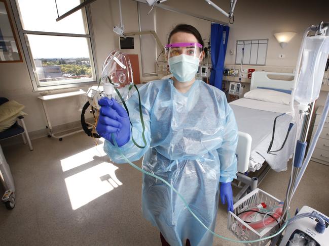 Frontline COVID-19 healthcare hero workers like Karlee Robson is an infectious diseases nurse based in Royal Melbourne Hospital's Infectious Disease ward, dealing all day with COVID-19 cases. Karlee dressed in full PPE holds a mask to pump humidified oxygen to a patient.     Picture: David Caird