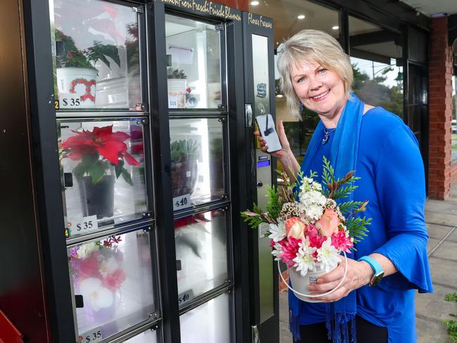 Christine Heart Savage buys flowers from Little Flower Box in Templestowe who are doing vending machines for flowers. Picture: Brendan Beckett