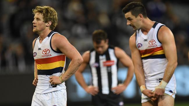 Rory Sloane and Taylor Walker (with Jarryd Blair rear) are seen after Sunday‘s draw. Picture: AAP