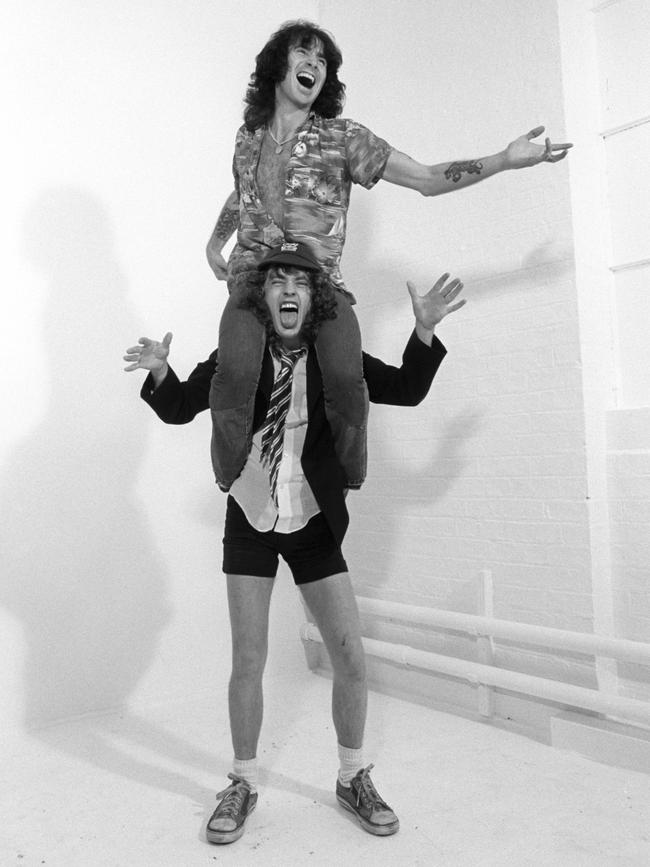 Bon Scott with Angus Young. (Photo: Fin Costello/Redferns)