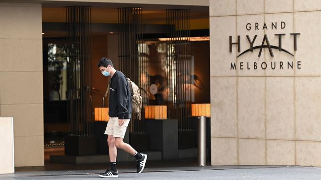 A man walks past the Grand Hyatt hotel in Melbourne on February 4