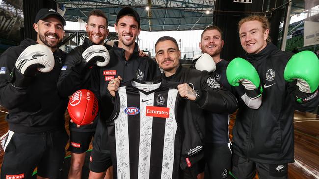 Kambosos Jr with (from left) Steele Sidebottom, Jeremy Howe, Scott Pendlebury, Taylor Adams and Beau McCreery is presented with a signed jersey. Picture: David Caird