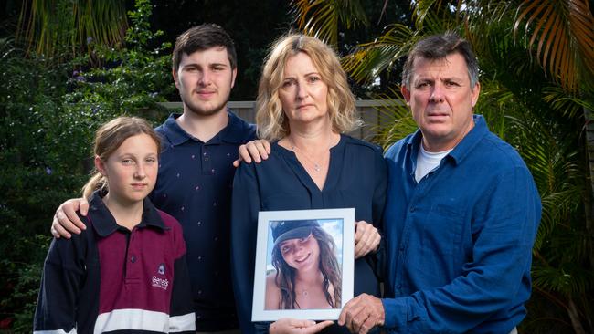 Too young: Kellie Postle holds a portrait of her daughter Alyssa, with her husband Troy and children, Ella and Adam. Picture: David Kelly.