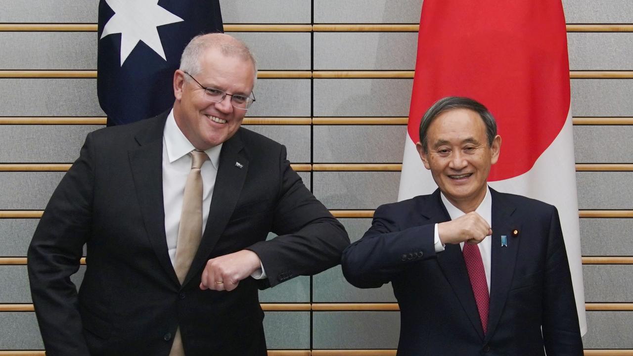 Australia’s Prime Minister Scott Morrison and Japan’s Prime Minister Yoshihide Suga bumped elbows at a bilateral meeting in Tokyo in November. Picture: Eugene Hoshiko/AFP