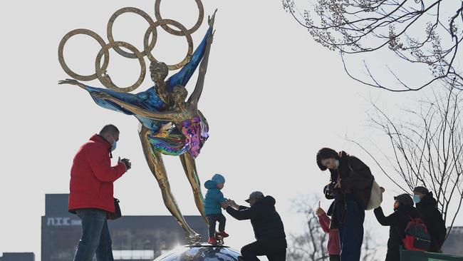 A child plays on a Winter Olympics sculpture in Shougang Park, Beijing this week. Picture: AFP