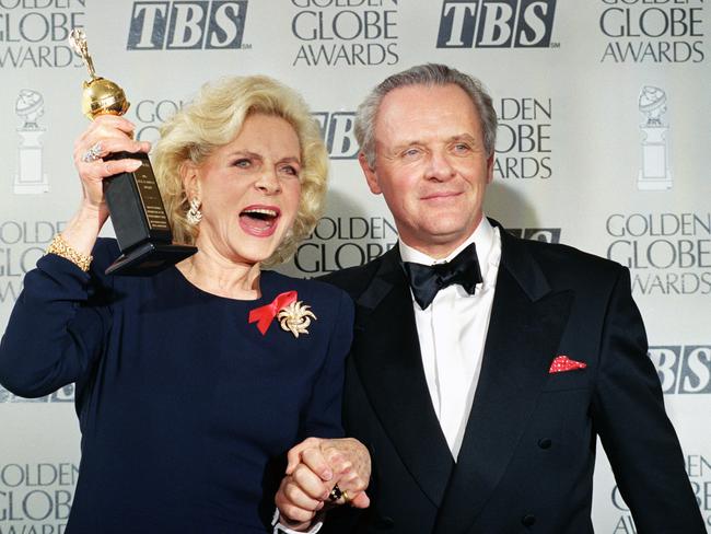 Still full of life ... Lauren Bacall holding up her Cecil B. DeMille Award for Lifetime Achievement as she holds hands with actor Sir Anthony Hopkins at the 50th annual Golden Globe Awards.