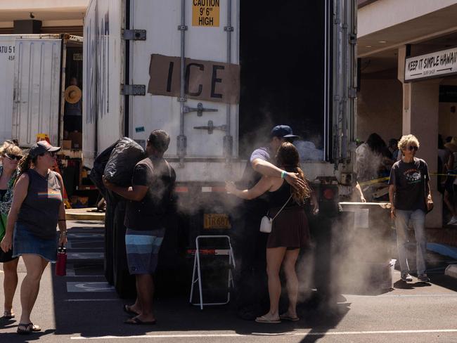 A woman hugs a volunteer unloading ice off a truck at a distribution centre for those affected by the Maui fires at Honokawai Beach Park in Napili-Honokowai, west of Maui, Hawaii. Picture: AFP