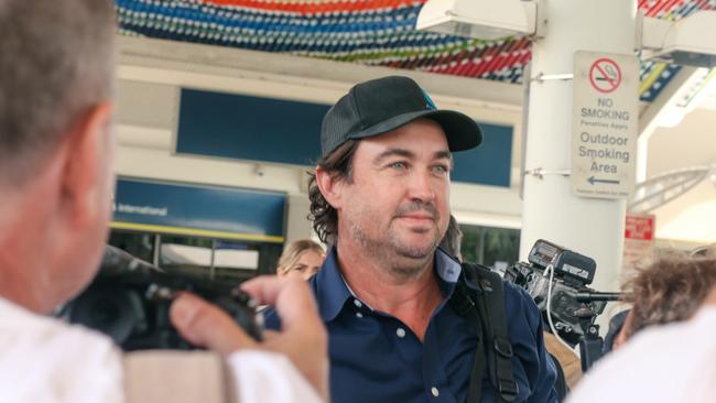 Matt Wright arrives in Darwin flanked by security to present himself to NT Police to face charges relating to the fatal crash that killed his friend and co-star Chris ‘Willow’ Wilson in February 2022. Picture: Glenn Campbell