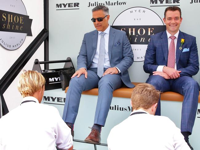 Australia Post boss Ahmed Fahour (pictured left) gets his shoes shined in the Birdcage at this year’s Melbourne Cup.