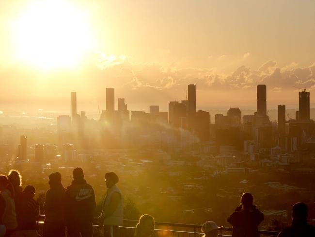 People watch the sunrise over Brisbane City from Mt Cootha, with a light fog over the river in some places, Mt Cootha on Monday 6th May 2024 - Photo Steve Pohlner