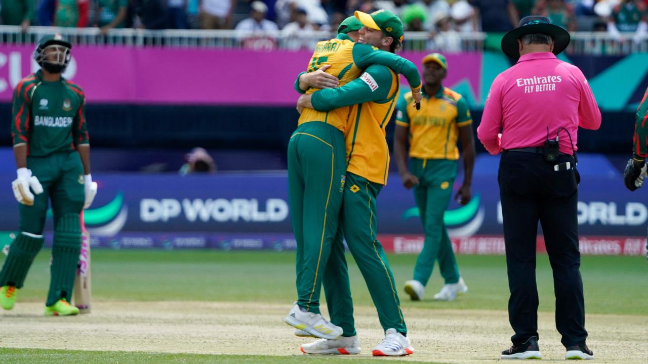 South Africa celebrate a narrow victory over Bangladesh. (Photo by TIMOTHY A. CLARY / AFP)