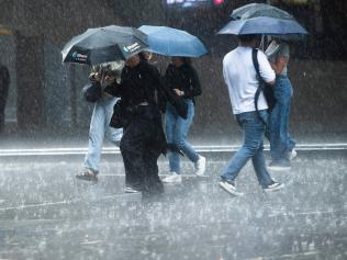 SYDNEY, AUSTRALIA.
NewsWire Photos. April 18, 2024.
Sydney-siders cross the Goulburn Street in the CBD as a brief heavy deluge crossed the city.  Wet Weather Sydney

Picture: NCA NewsWire / Jeremy Piper