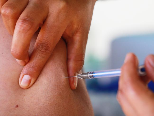 A medical worker receives the Pfizer/BioNTech vaccine.