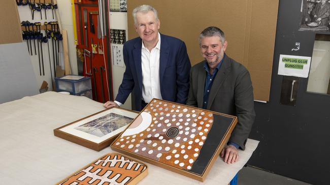 Federal Arts Minister Tony Burke and National Gallery director Nick Mitzevich with Namatjira's Central Australian Landscape, Sunrise chasing away the night and Corroboree site two, which will be on display at Araluen Arts Centre from June.