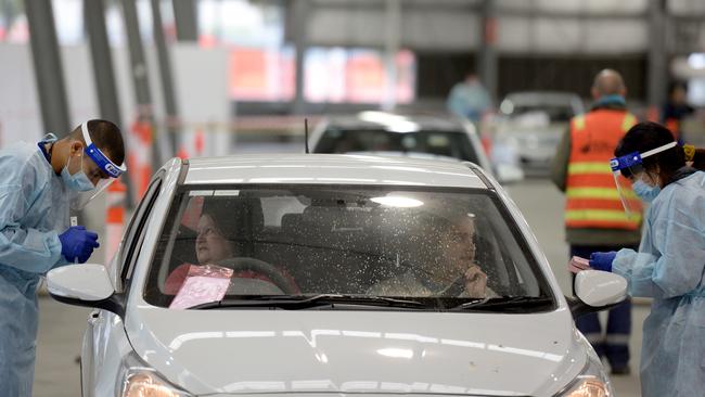 Drivers get tested for COVID-19 at the drive-thru clinic at Royal Melbourne Showgrounds. Picture: Andrew Henshaw