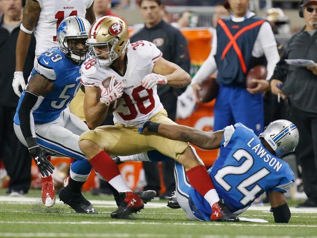 Jarryd Hayne #38 of the San Francisco 49ers looks to break the tackle by Nevin Lawson #24 of the Detroit Lions in the fourth quarter at Ford Field on December 27. Picture: Gregory Shamus/Getty Images