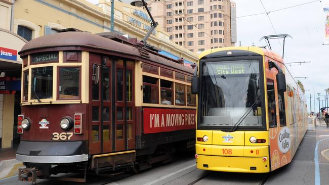 H-Class tram leaves Glenelg alongside a new electric tram.