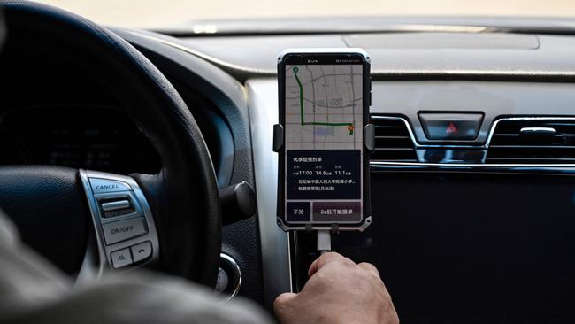 A Chinese driver using the Didi Chuxing ride-hailing app on his smartphone. Picture: AFP