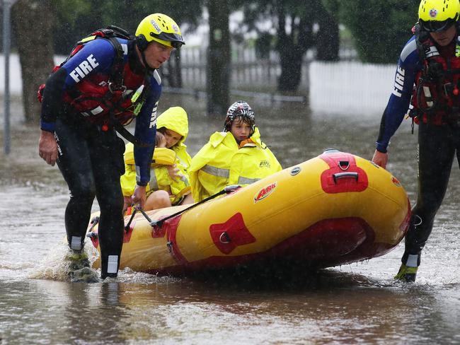 Rochelle Wright and her kids Amelia, 1, and William, 5, are evacuated from their house in Raymond Terrace. Picture: Peter Lorimer.