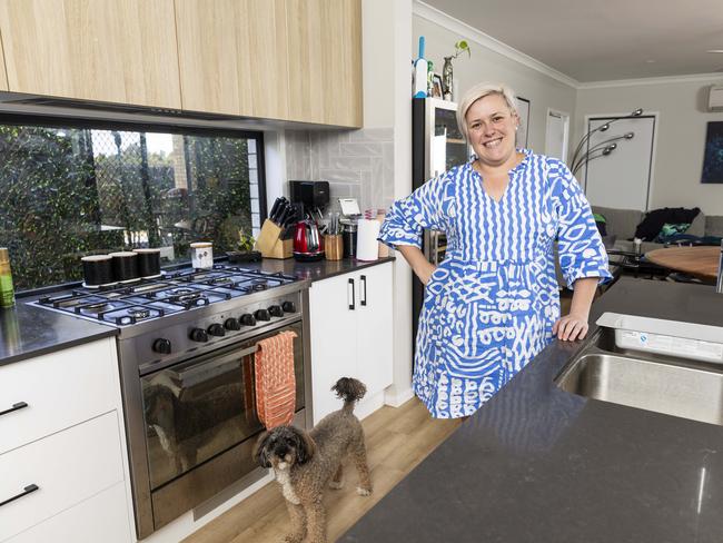 Kiah Coupland was assisted by her mother as a guarantor on her first home.  Pictured is Kiah inside her home with her dog Coco.