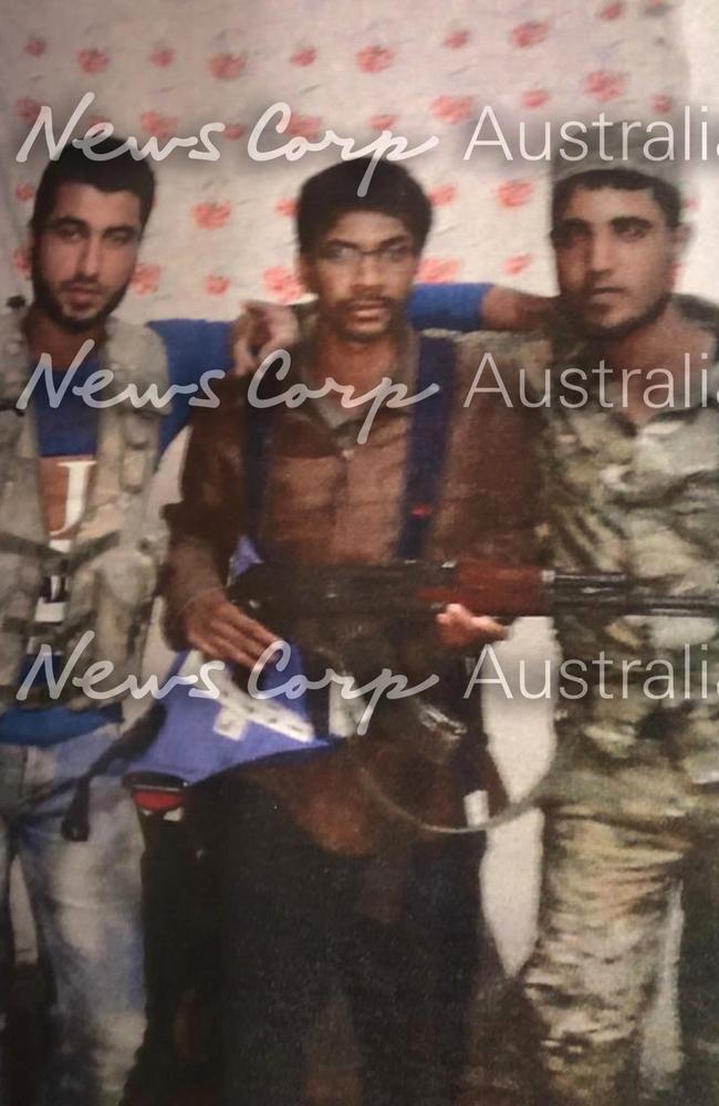  This is the picture that the judge said convinced him Melbourne-born Neil Prakash was an ISIS terrorist. The photograph, showing Prakash with a gun and posing with two men in military-style uniform, was a key part of the evidence used against him.