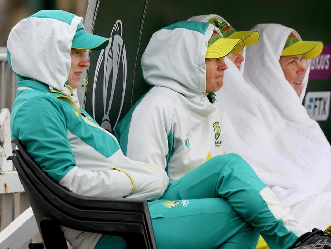 New Zealand players and staff wrap up against the cold during the Women's Cricket World Cup match between the Australia and Bangladesh at the Basin Reserve in Wellington on March 25, 2022. (Photo by Marty MELVILLE / AFP)