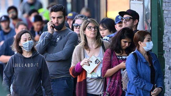 People queue outside a Centrelink office in Melbourne in March 2020. Picture: Getty Images