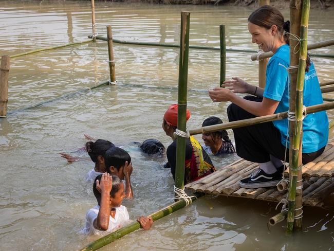 Olympian Emma McKeon, a UNICEF Australia ambassador, visits one the charity's SwimSafe programs in Sreepur, Gazipur Union, Gazipur, Bangladesh, where children are learning to swim in a bamboo structure in a muddy pond. Picture: Jason Edwards