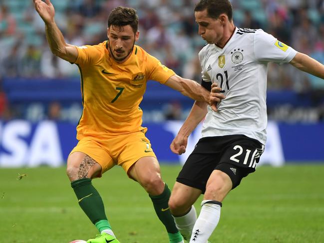 Australia's forward Mathew Leckie (L) is tackled by Australia's midfielder Massimo Luongo during the 2017 Confederations Cup group B football match between Australia and Germany at the Fisht Stadium in Sochi on June 19, 2017. / AFP PHOTO / Patrik STOLLARZ