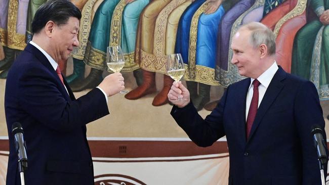 Russian President Vladimir Putin and China's President Xi Jinping make a toast during a reception following their talks at the Kremlin in Moscow in March. Picture: Pavel Byrkin / SPUTNIK / AFP