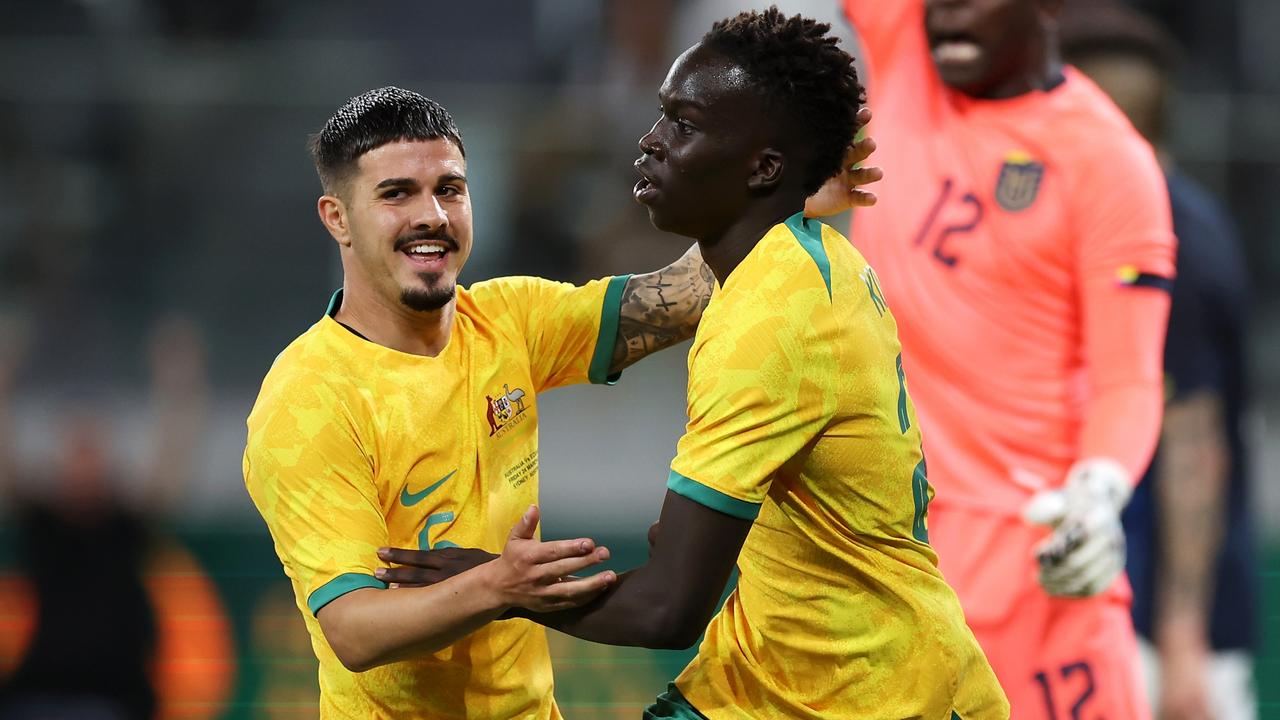 SYDNEY, AUSTRALIA - MARCH 24: Garang Kuol (r) of the Socceroos celebrates with Marco Tilio of the Socceroos after scoring a goal during the International Friendly match between the Australia Socceroos and Ecuador at CommBank Stadium on March 24, 2023 in Sydney, Australia. (Photo by Mark Kolbe/Getty Images)