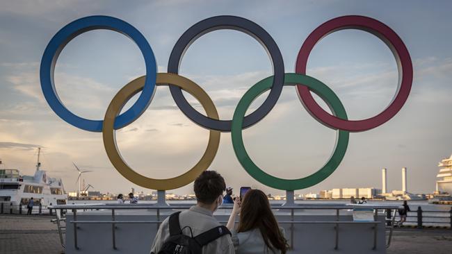 YOKOHAMA, JAPAN - JULY 22: People take photographs of Olympics rings on July 22, 2021 in Yokohama, Japan. Olympics opening ceremony director, Kentaro Kobayashi, has been sacked on the eve of the event after footage emerged in which he appeared to make jokes about the Holocaust. Mr Kobayashi follows a number of other figures involved in the Tokyo Olympic Games who have had to step down for inappropriate remarks. (Photo by Yuichi Yamazaki/Getty Images)