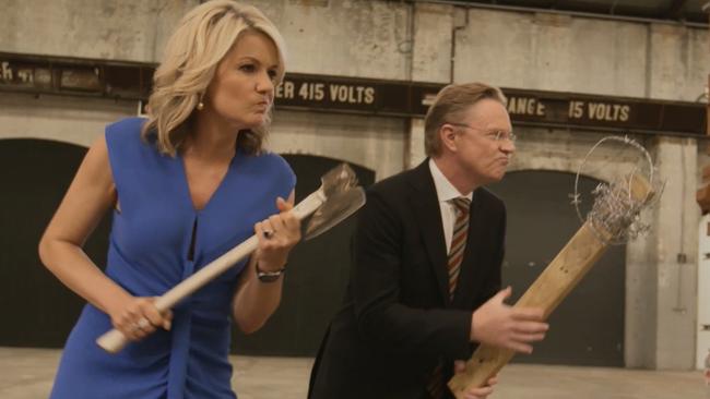 Serious weapons ... Sandra Sully grips an axe while Hugh Riminton has a piece of wood wrapped in barbed wire. Picture: Supplied