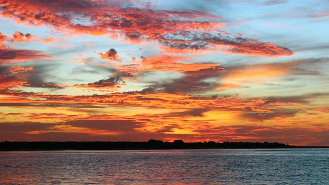 The sun setting over a still Timor Sea off Darwin. The photographer was on a sunset cruise, which takes in some of the city's most iconic landmarks from the harbour. Picture: Caroline Berdon