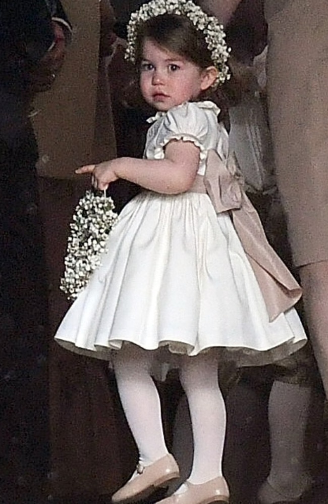 Charlotte was wearing a pretty white bridesmaid dress with pale pink bow, the bespoke outfit was designed by Pepa &amp; Co. Picture: Samir Hussein/Samir Hussein/WireImage