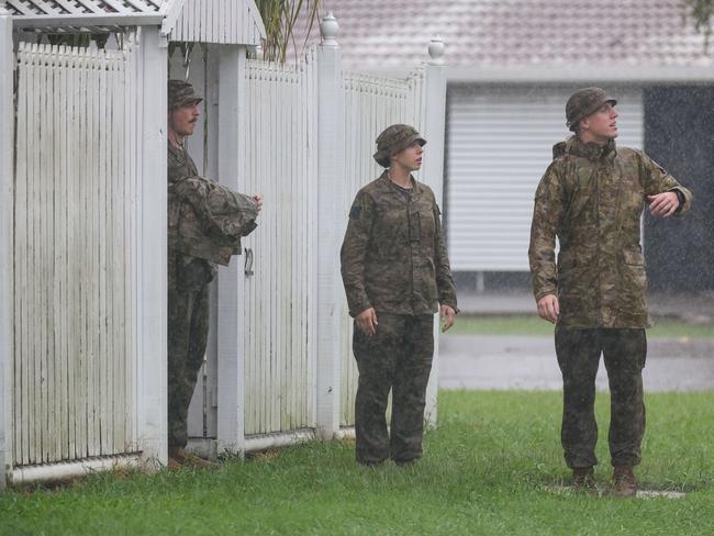 ADF personnel door knocking homes in Hermit Park Townsville as flood waters start to rise. Picture: Adam Head