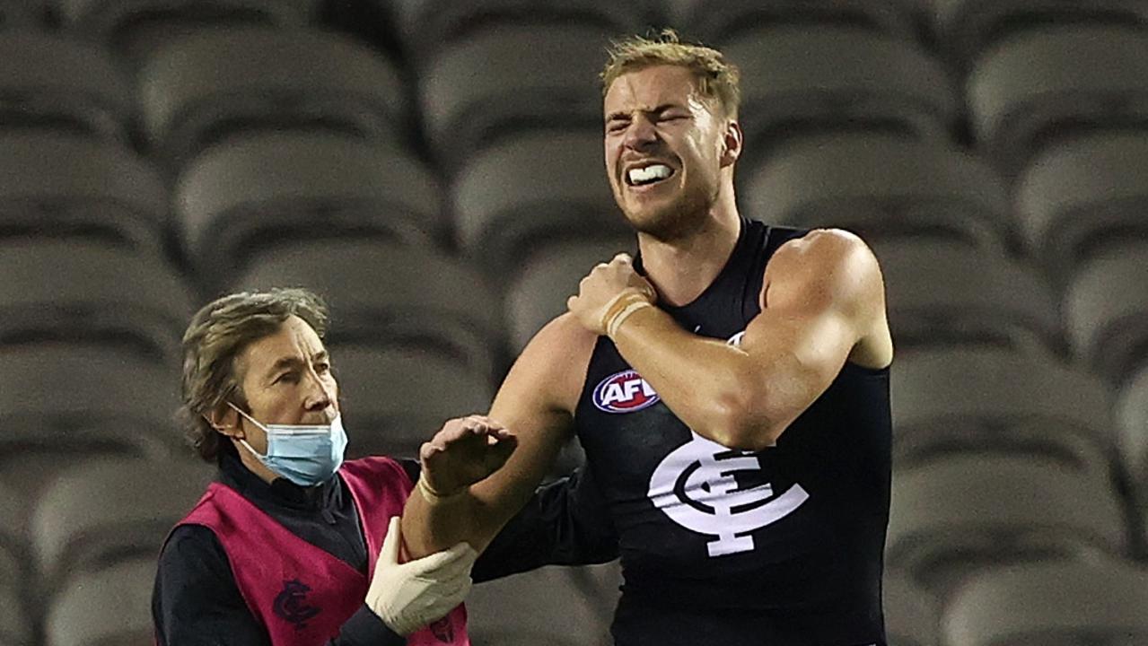 Harry McKay grimaces after hurting his shoulder against Gold Coast.